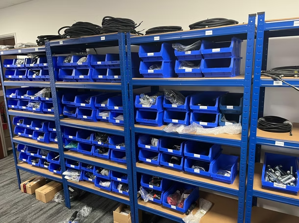 The inside of Hydraulic Attachment Services with shelves filled with all sorts of hydraulic attachments.